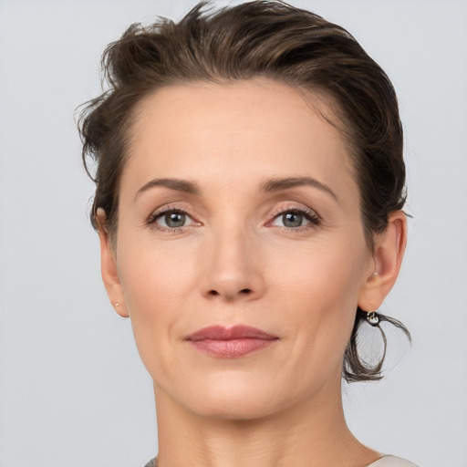 Joyful white adult female with medium  brown hair and brown eyes