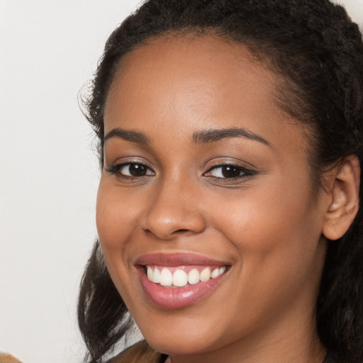 Joyful white young-adult female with long  brown hair and brown eyes