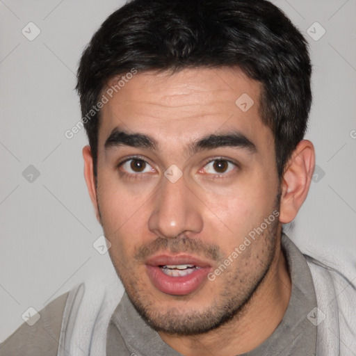 Joyful white young-adult male with short  black hair and brown eyes