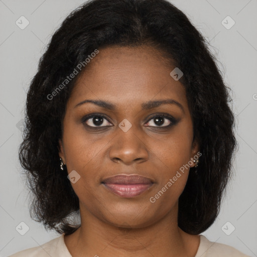 Joyful black young-adult female with long  brown hair and brown eyes