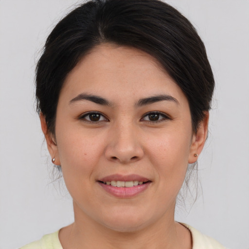 Joyful asian young-adult female with medium  brown hair and brown eyes