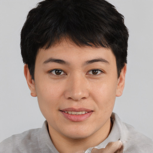 Joyful asian young-adult male with short  brown hair and brown eyes