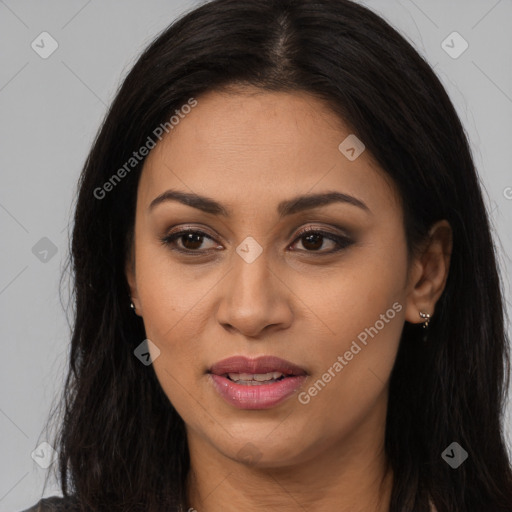 Joyful latino young-adult female with long  brown hair and brown eyes