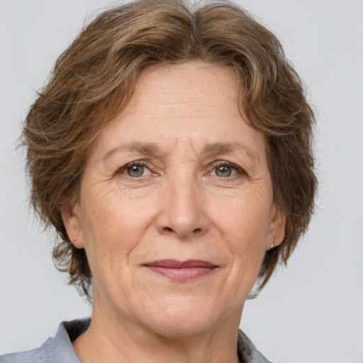 Joyful white middle-aged female with medium  brown hair and brown eyes