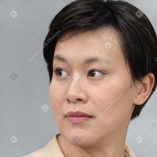 Neutral asian young-adult female with medium  brown hair and brown eyes