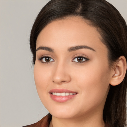 Joyful white young-adult female with long  brown hair and brown eyes