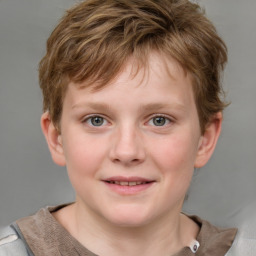 Joyful white child male with short  brown hair and blue eyes