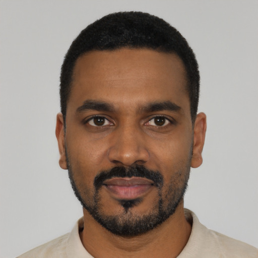 Joyful black young-adult male with short  black hair and brown eyes