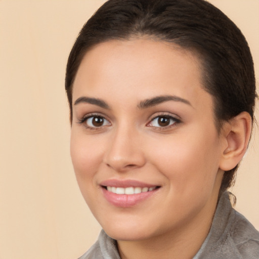 Joyful white young-adult female with long  brown hair and brown eyes