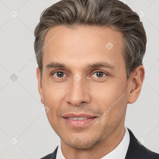 Joyful white adult male with short  brown hair and brown eyes