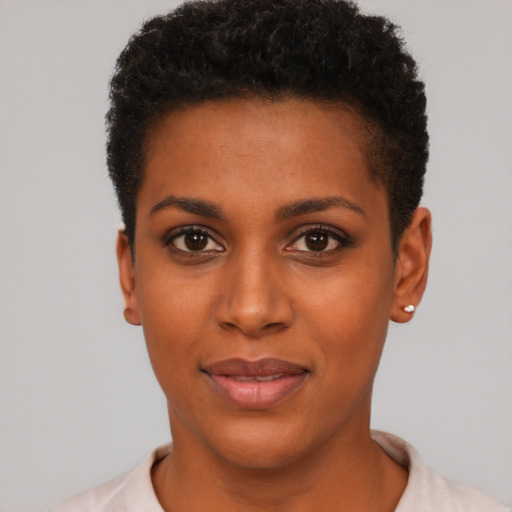 Joyful black young-adult female with short  black hair and brown eyes