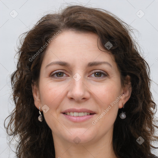 Joyful white adult female with long  brown hair and brown eyes