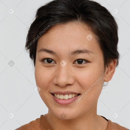 Joyful asian young-adult female with short  brown hair and brown eyes