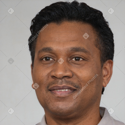 Joyful black adult male with short  black hair and brown eyes