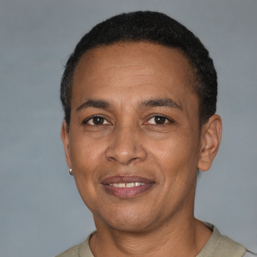 Joyful latino adult male with short  brown hair and brown eyes