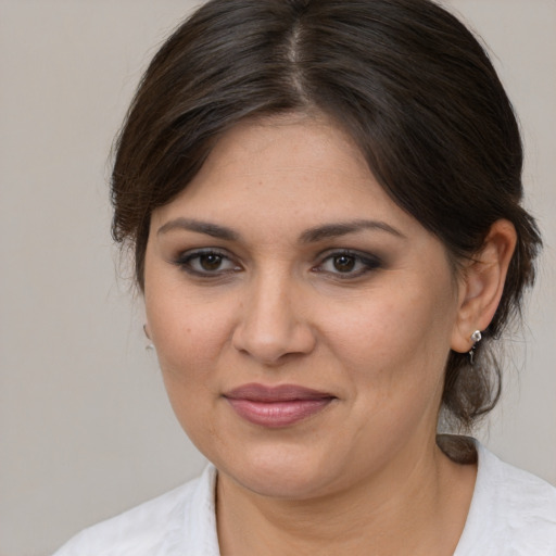 Joyful white young-adult female with medium  brown hair and brown eyes