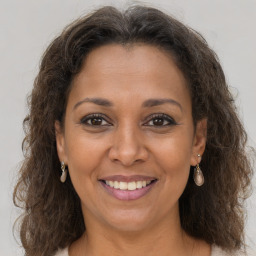 Joyful black adult female with medium  brown hair and brown eyes