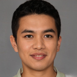 Joyful latino young-adult male with short  brown hair and brown eyes