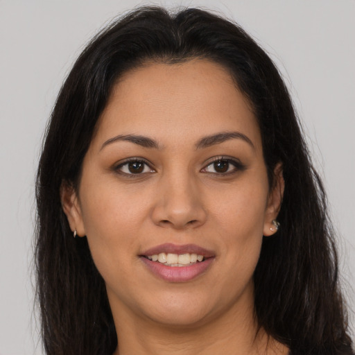 Joyful latino young-adult female with long  brown hair and brown eyes