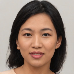 Joyful asian young-adult female with medium  black hair and brown eyes