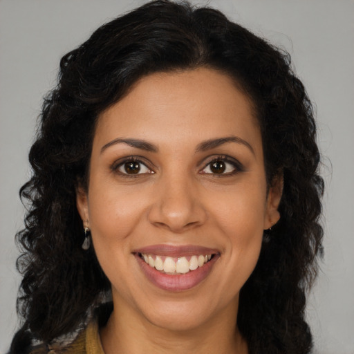 Joyful latino young-adult female with long  brown hair and brown eyes