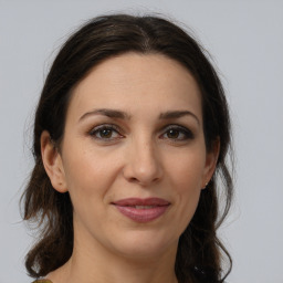 Joyful white adult female with medium  brown hair and brown eyes