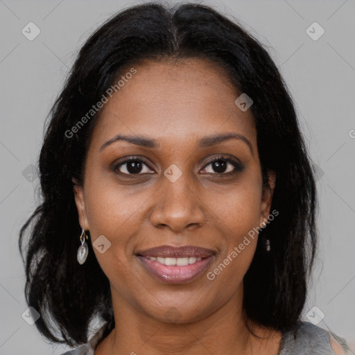 Joyful black adult female with medium  brown hair and brown eyes