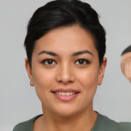 Joyful asian young-adult female with short  black hair and brown eyes