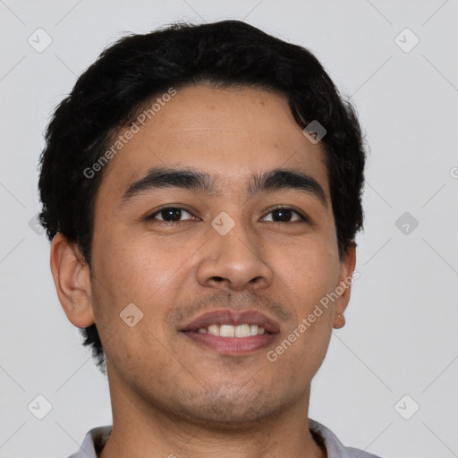 Joyful latino young-adult male with short  black hair and brown eyes