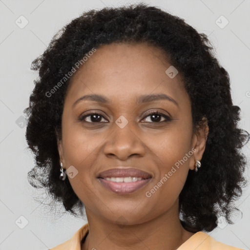 Joyful black adult female with medium  brown hair and brown eyes