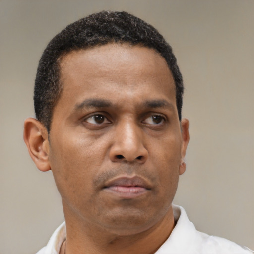 Neutral latino adult male with short  brown hair and brown eyes