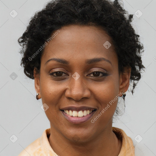 Joyful black young-adult female with short  brown hair and brown eyes