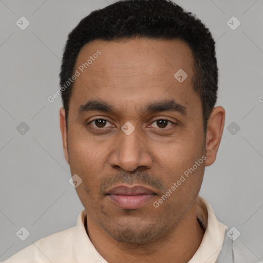 Joyful latino adult male with short  black hair and brown eyes