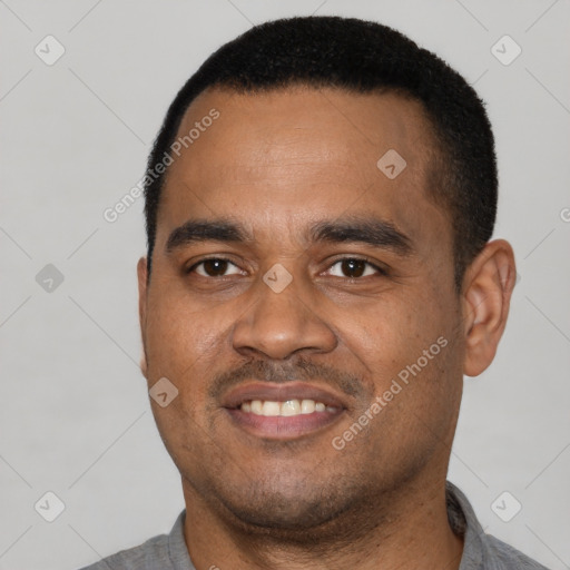 Joyful latino young-adult male with short  black hair and brown eyes