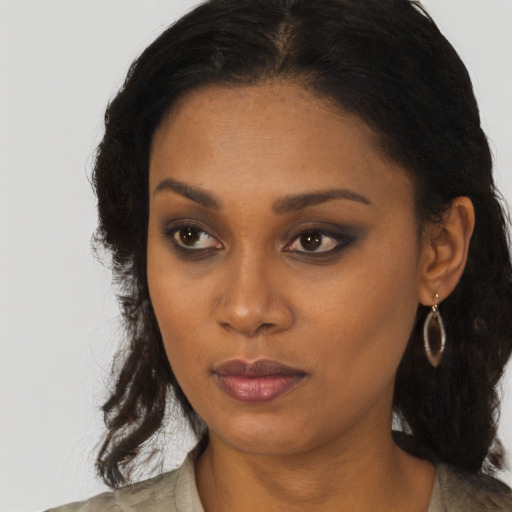 Neutral black young-adult female with medium  brown hair and brown eyes