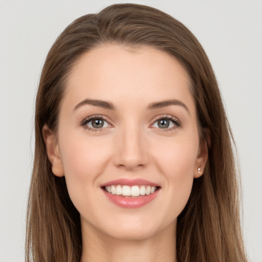 Joyful white young-adult female with long  brown hair and grey eyes