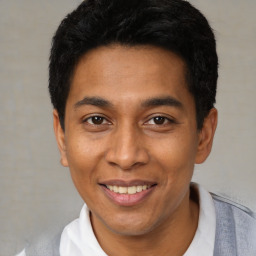 Joyful latino young-adult male with short  black hair and brown eyes