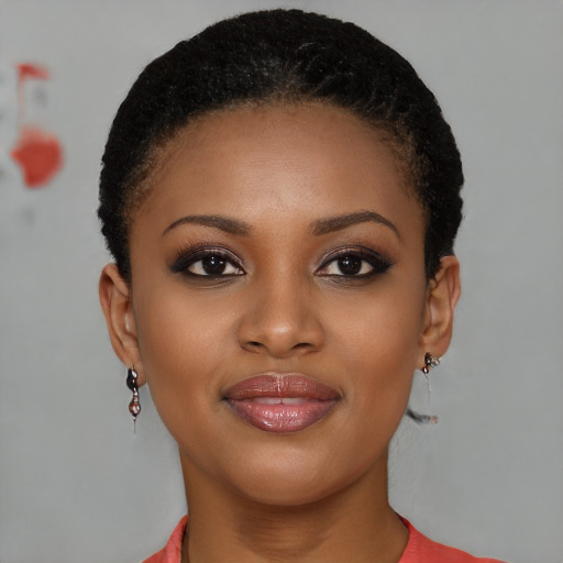 Joyful black young-adult female with short  brown hair and brown eyes