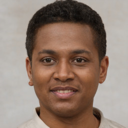 Joyful latino young-adult male with short  brown hair and brown eyes