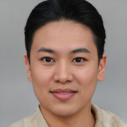 Joyful asian young-adult male with short  brown hair and brown eyes