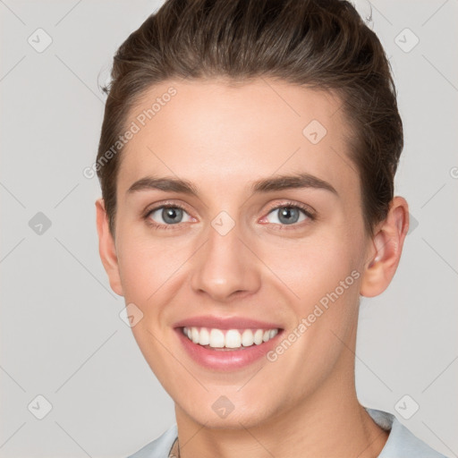 Joyful white young-adult female with short  brown hair and grey eyes