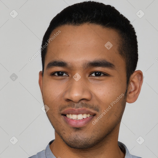 Joyful latino young-adult male with short  black hair and brown eyes