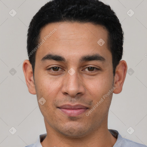 Joyful latino young-adult male with short  black hair and brown eyes