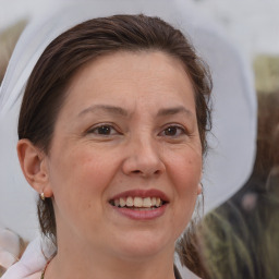 Joyful white adult female with medium  brown hair and brown eyes