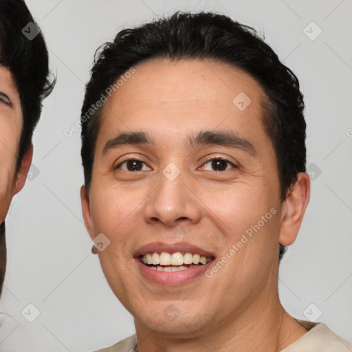 Joyful white young-adult male with short  black hair and brown eyes