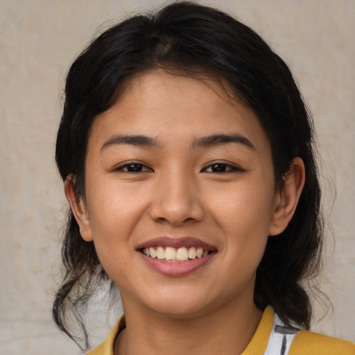Joyful asian young-adult female with medium  black hair and brown eyes