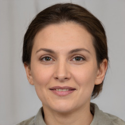 Joyful white adult female with medium  brown hair and brown eyes