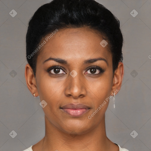 Joyful black young-adult female with short  black hair and brown eyes