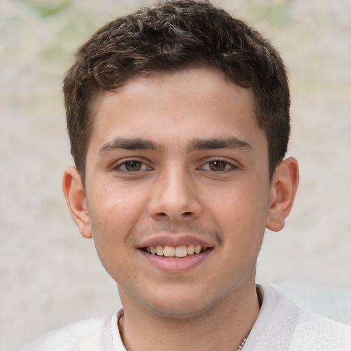 Joyful white child male with short  brown hair and brown eyes