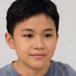 Joyful asian child male with short  brown hair and brown eyes